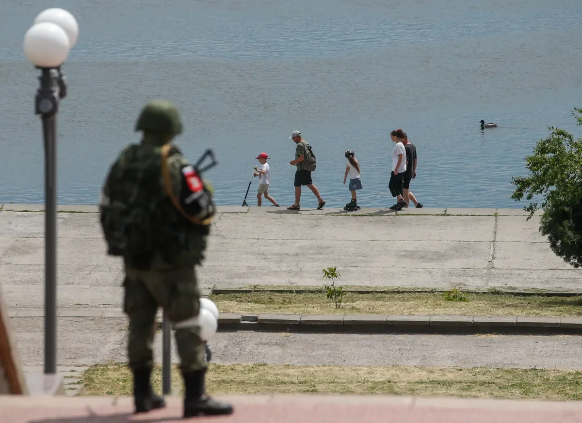 Kherson, Russia’s serviceman stands watch. Photo by EPA-EFE/SERGEI ILNITSKY