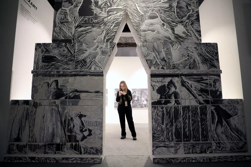 A person looks at their phone during the press preview day of the Catalog contemporary art fair in Moscow, Russia, 11 April 2024. Photo: EPA-EFE/MAXIM SHIPENKOV