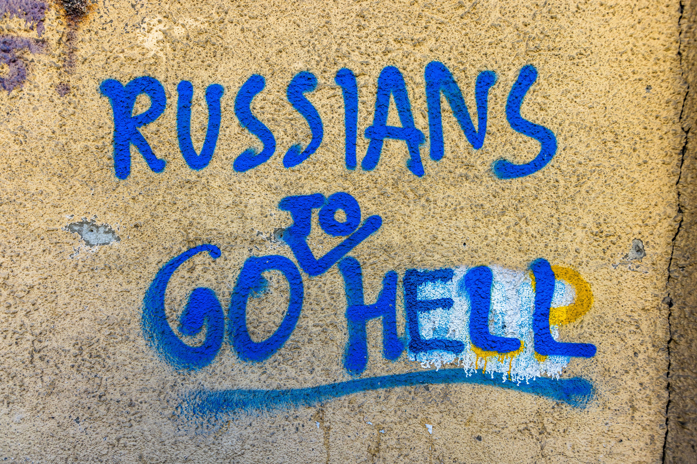 Надпись Russians Go to Hell в цветах украинского флага на стене дома. Тбилиси, Грузия. 12 сентября 2023 года. Фото: Georg Berg / Alamy / Scanpix / LETA
