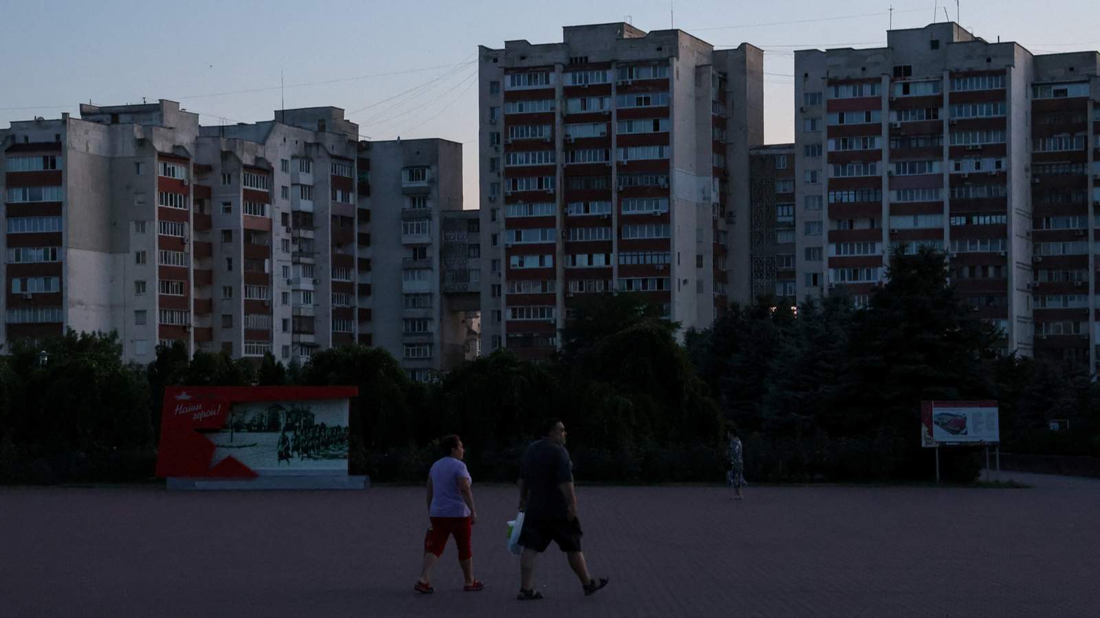 Люди идут по темной улице во время отключения электроэнергии в Евпатории, Крым, Украина, 5 июля 2026 года. Фото: Алексей Павлишак / Reuters / Scanpix / LETA<br>